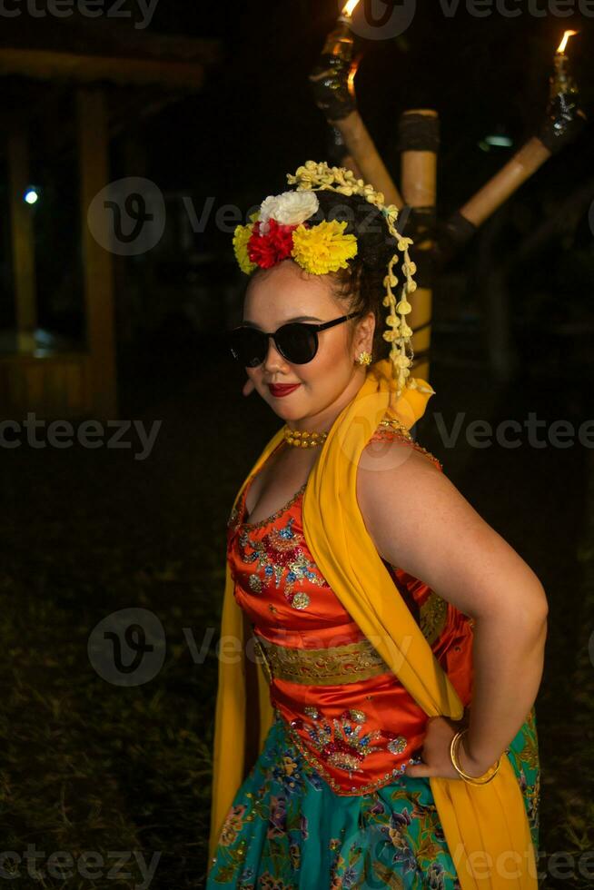 portrait of a teenage girl with sunglasses and a pretty flower posing very beautifully photo