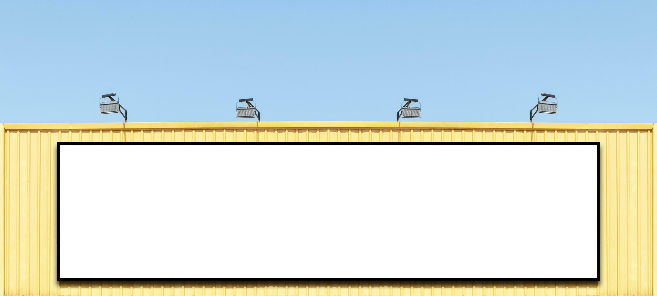 Mock up white background billboard on yellow building with spot light photo