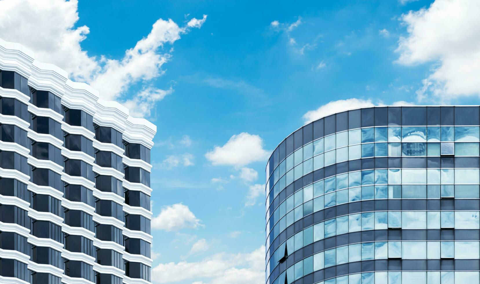 Two modern office building with blue sky background photo