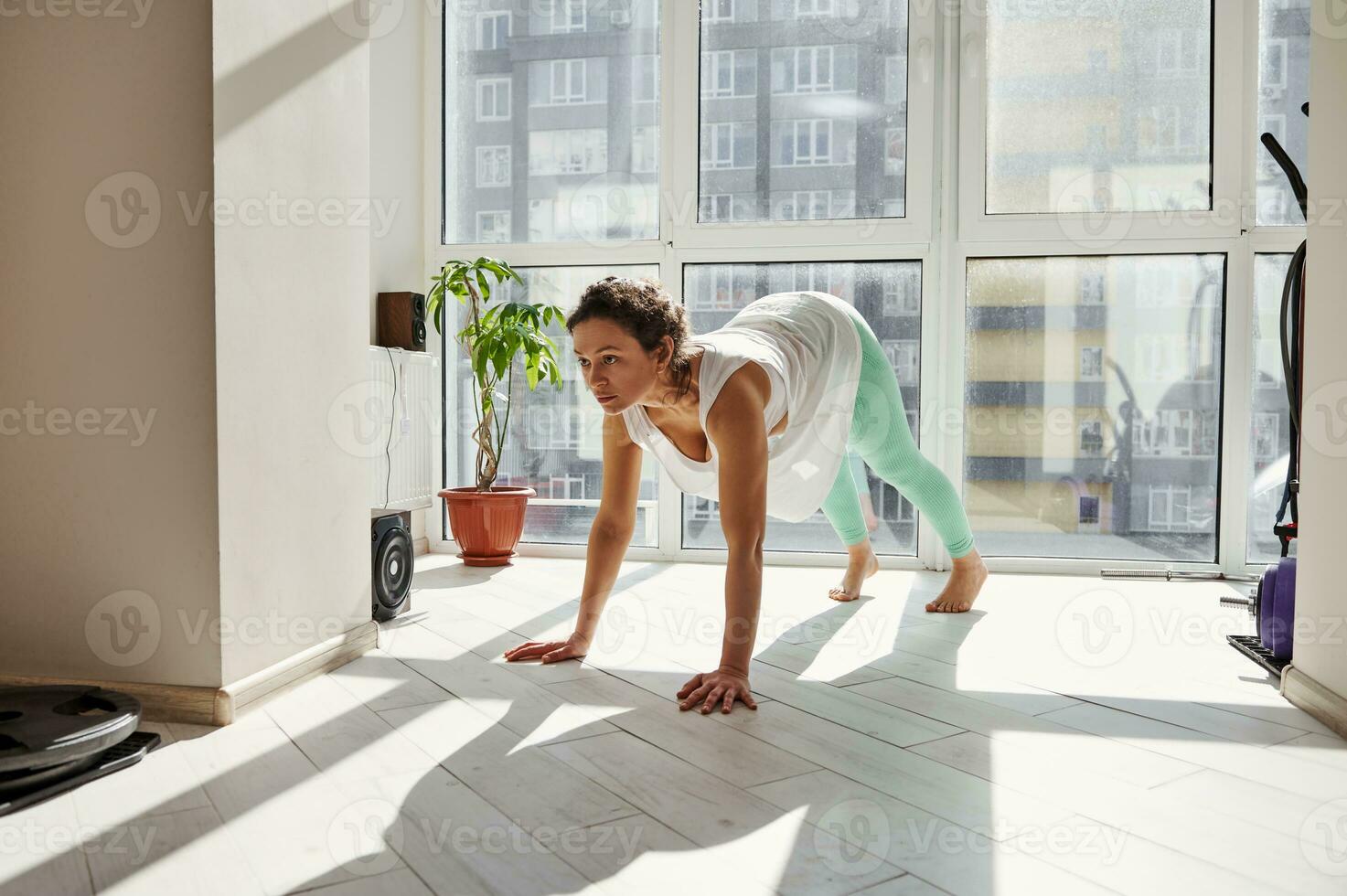 Young woman practicing Yoga postures at home. Yoga Pose Of Upward Facing Dog photo