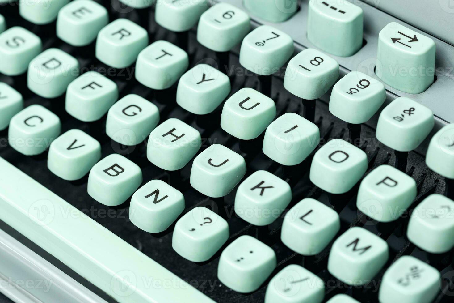 Vintage green typewriter keys background. Selective focus photo