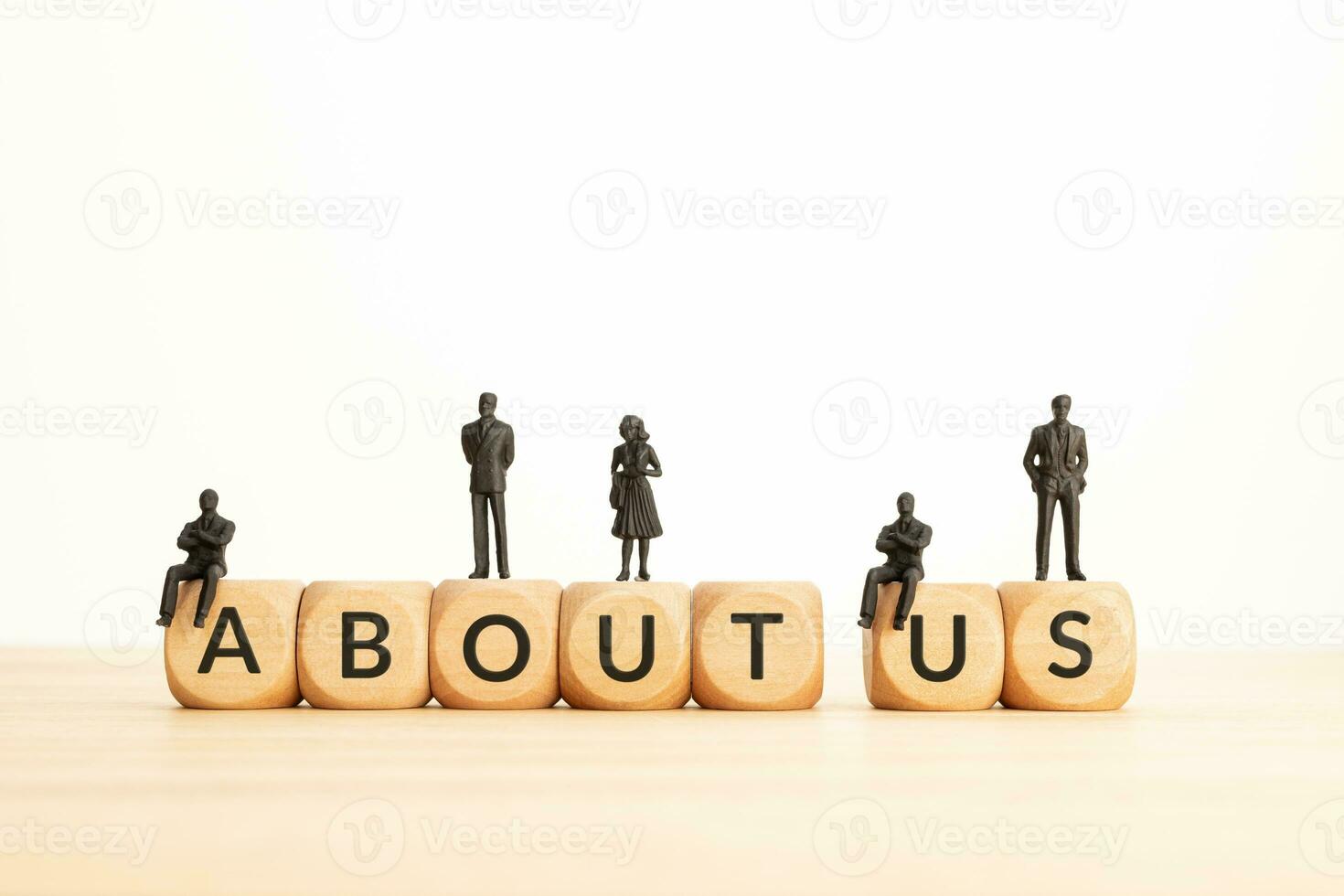 About Us phrase on wooden blocks and figurines. Copy space photo