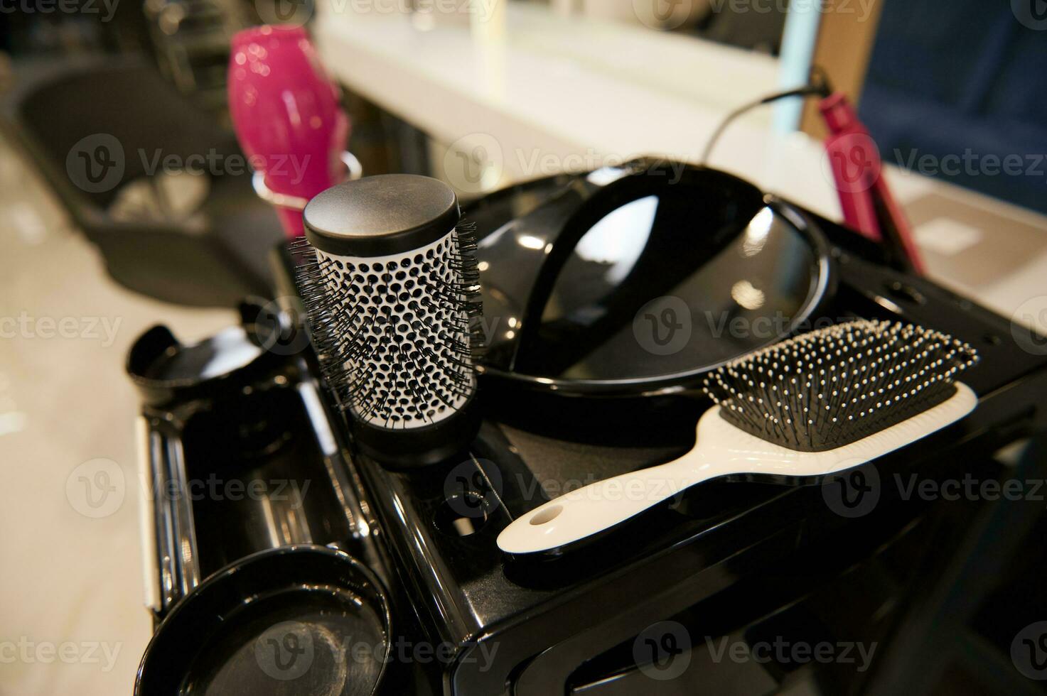 Focus on various hair brushes for combing and styling hair used in hairdressing salon and barber shop photo