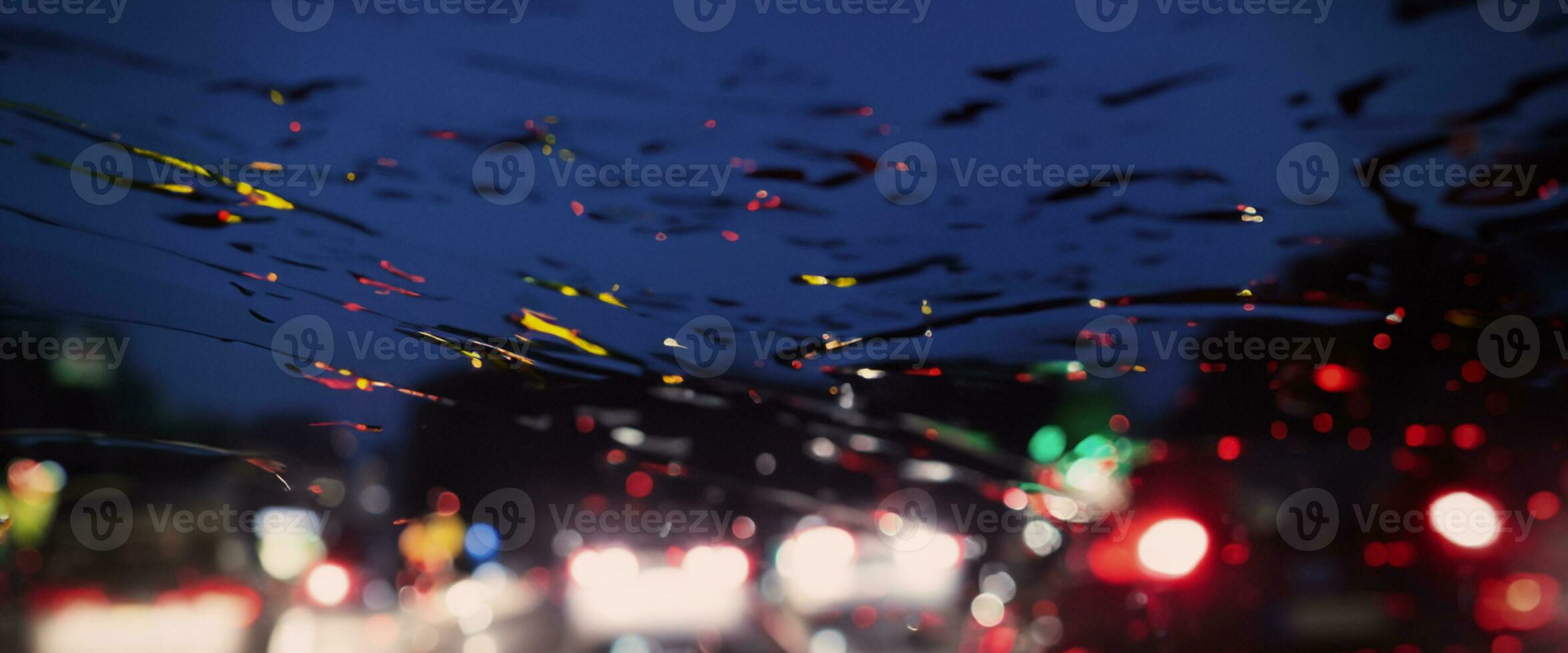 Driving in raining. Rain on car windshield or car window in rainy season and blurry traffic road in background. Rain drops on car mirror. Road in rain. Drizzle raining decreases driving visibility. photo