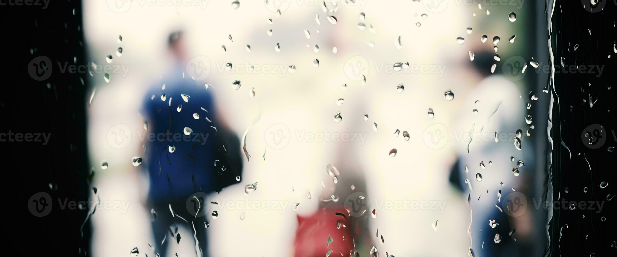 Rain drop on window glass of coffee shop and blurry city life background. Rainy season and blurry people city day life or bokeh night lights outside window. Coffee shop window covered with rain water photo