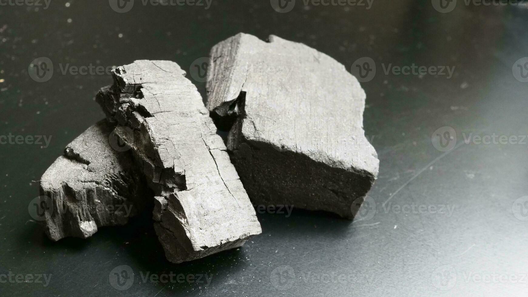 Natural wood charcoal traditional charcoal or hard wood charcoal on wooden table top view. photo