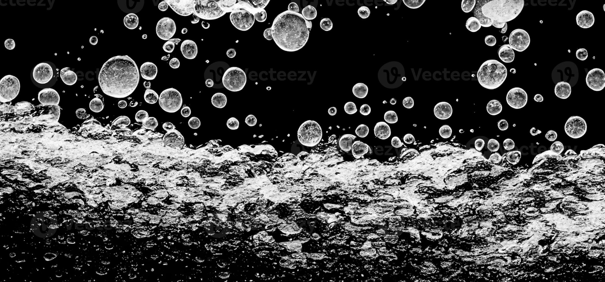 Soda water bubbles splashing underwater against black background. photo