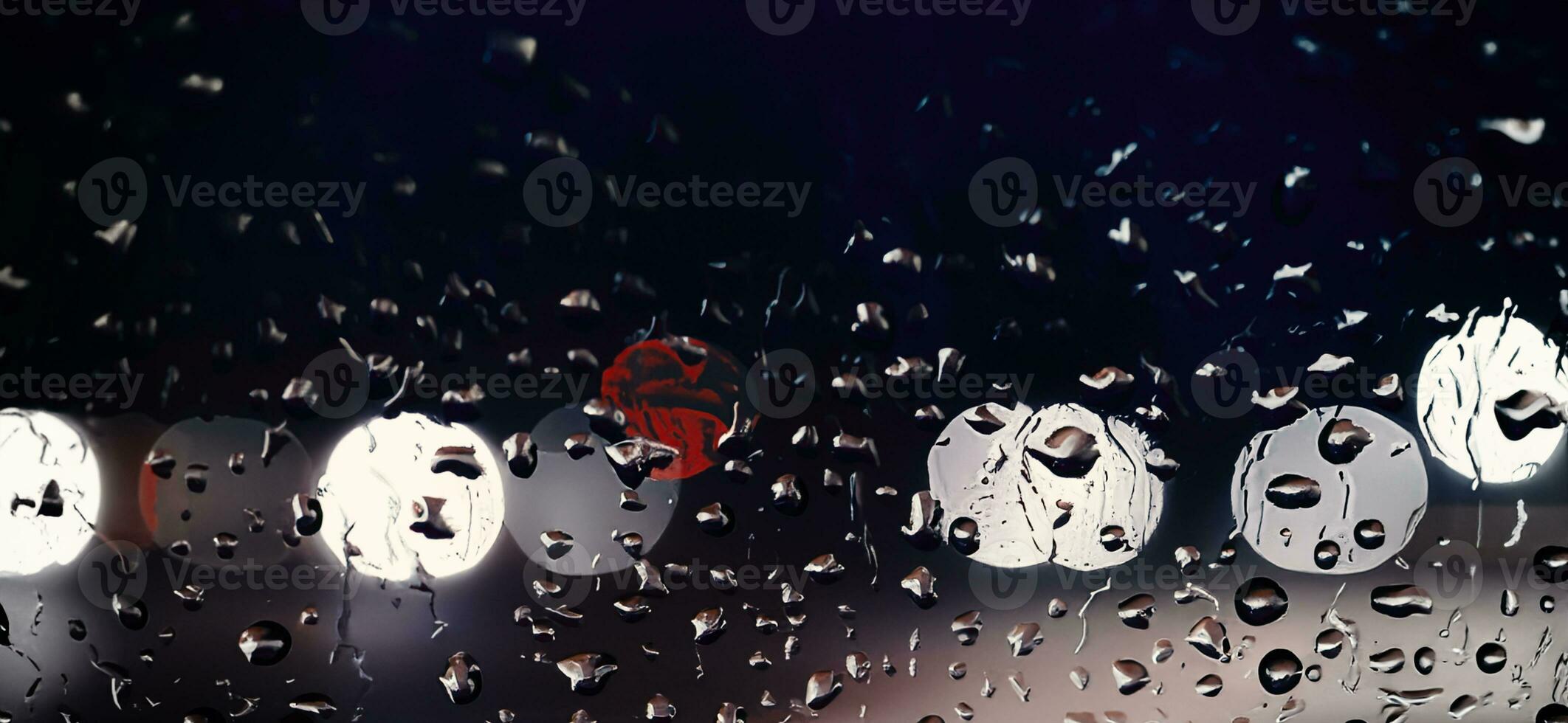 Rain shower on car windshield or car window and blurry road in background. photo