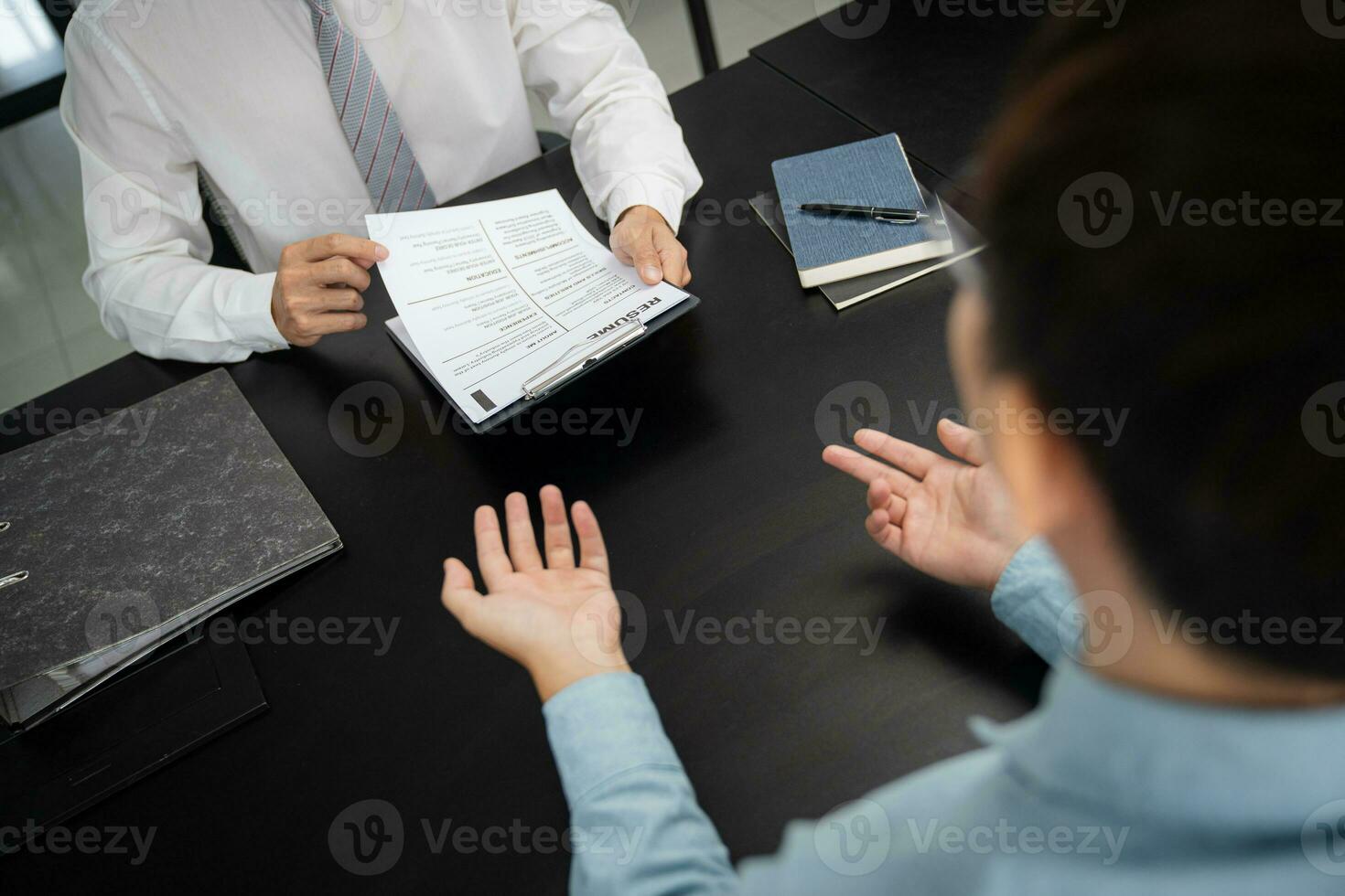 Examiner reading a resume during job interview at office Business and human resources concept. photo