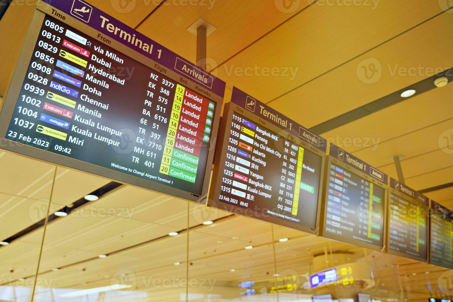 Flight information board at Singapore Changi Airport 31 March 2023 Flights information board and machine in airport terminal. photo