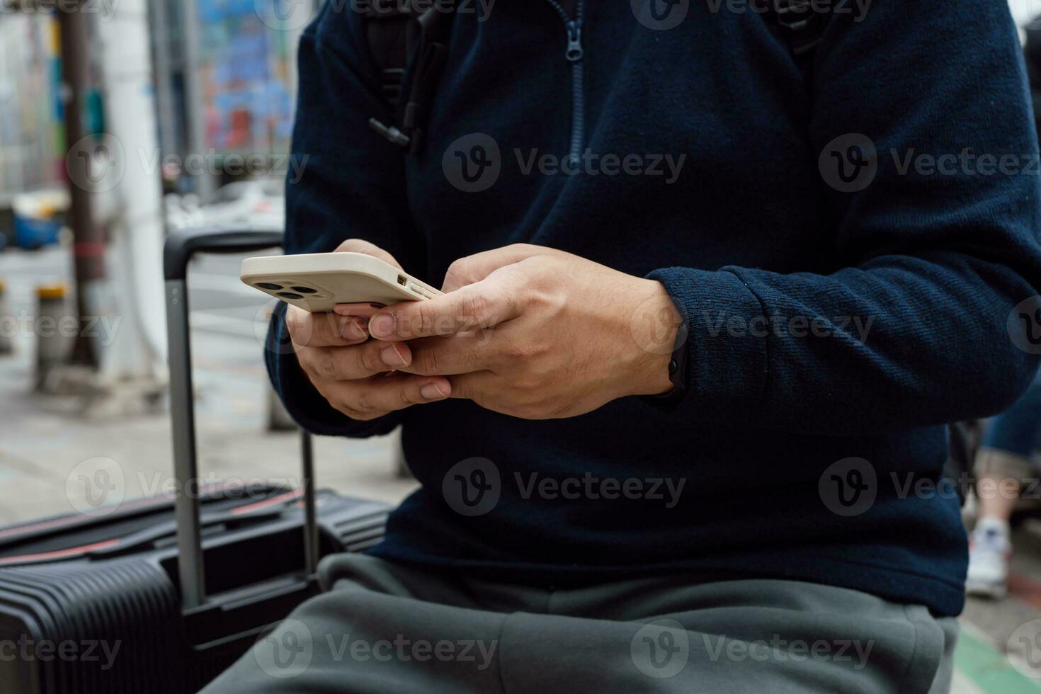 Man in downtown city street ordering taxi using smart phone app Booking taxi using application online on smart phone photo