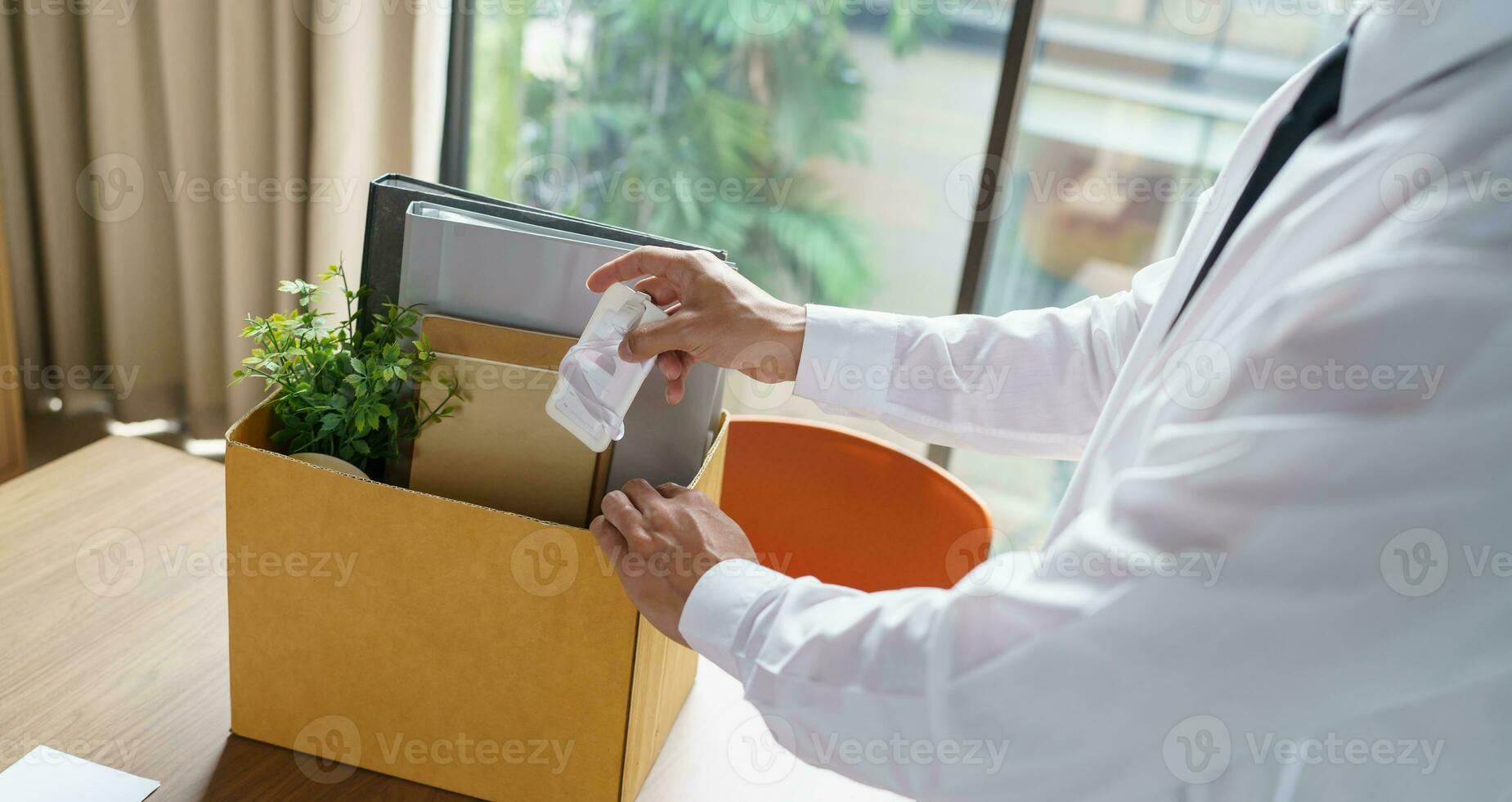 Quit Job Business man sending resignation letter and packing Stuff Resign Depress or carrying business cardboard box in office. Change of job or fired from company. photo