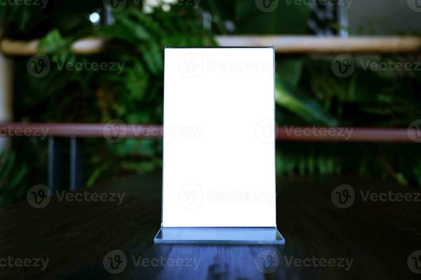 Mock up Menu frame standing on wood table in Bar restaurant cafe. space for text. photo
