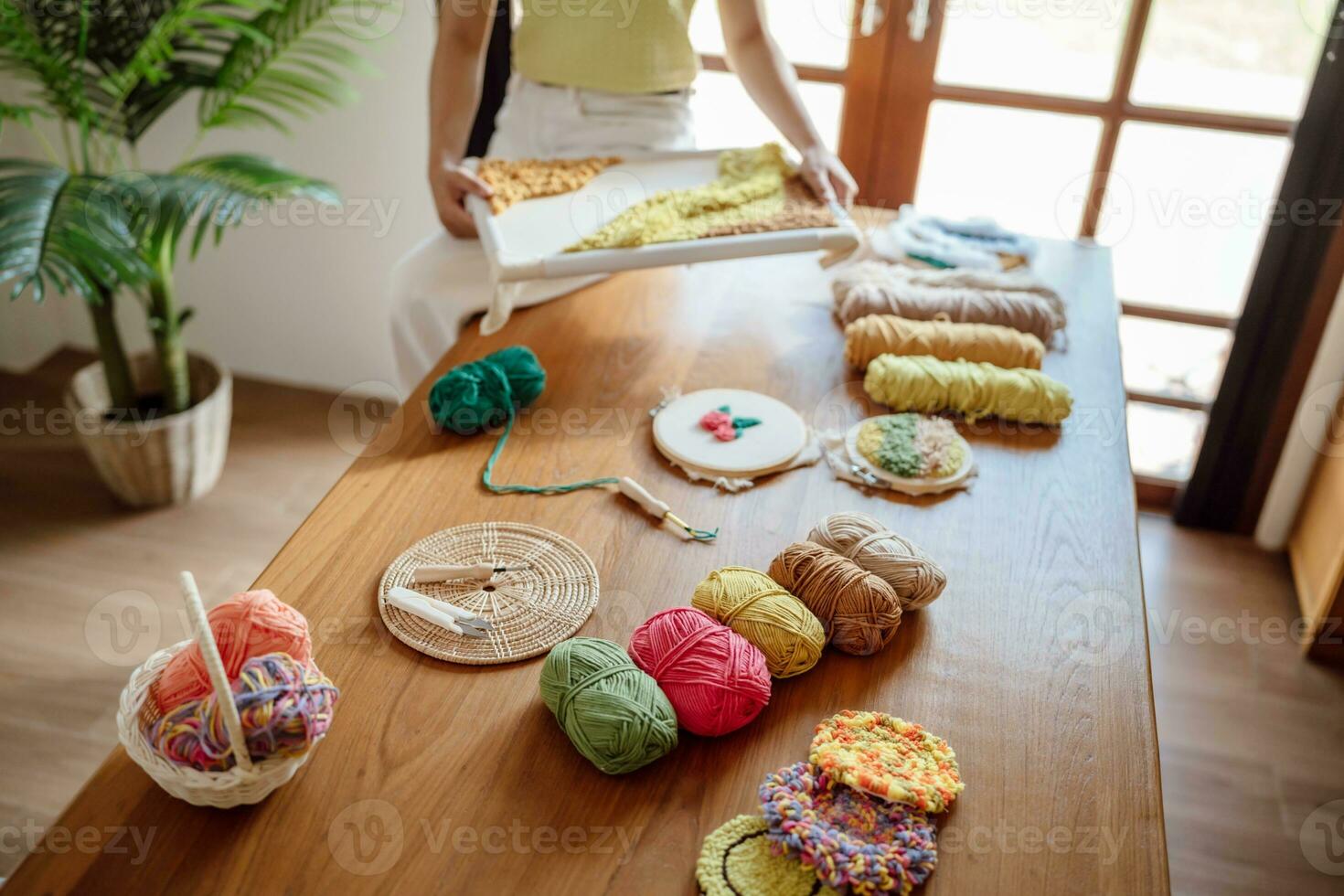 Punch needle. Asian Woman making handmade Hobby knitting in studio workshop. designer workplace Handmade craft project DIY embroidery concept. photo