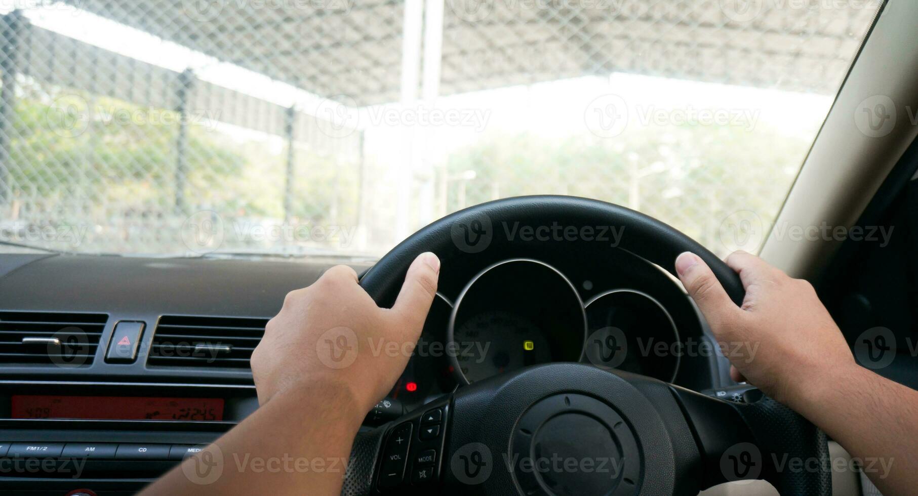 Man driving with both hands on steering wheel selective focus. safety driving car photo