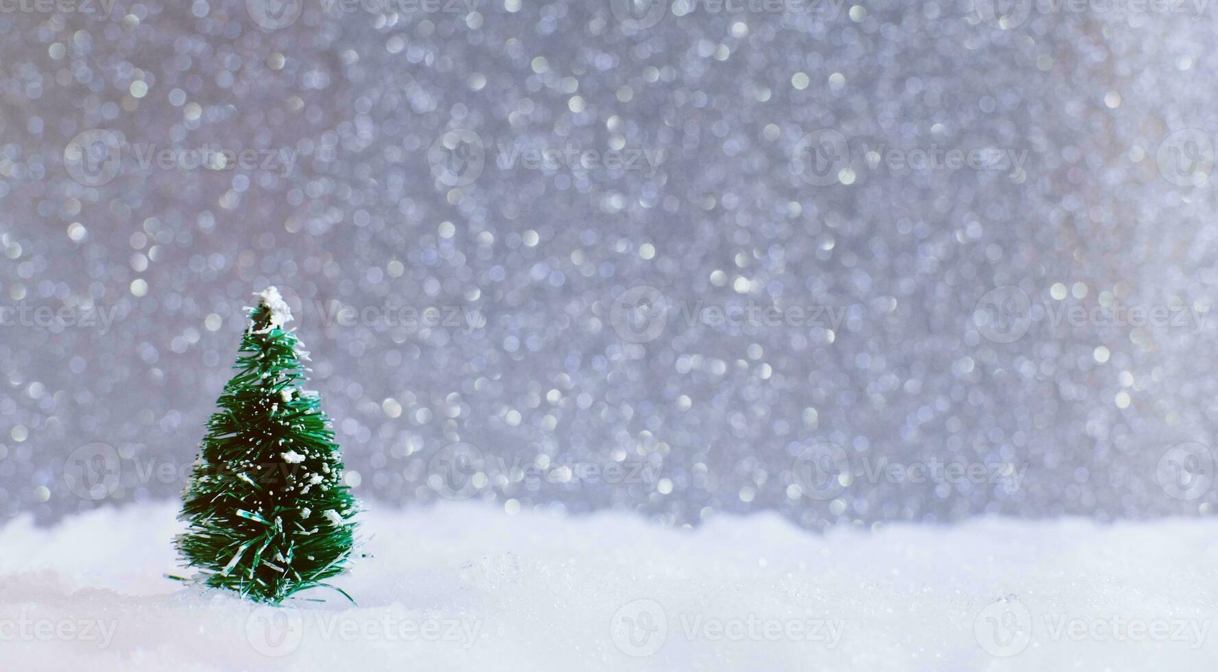 Christmas home decoration with Little handmade gift box in a snow covered miniature evergreen forest and bokeh light for copy space. photo