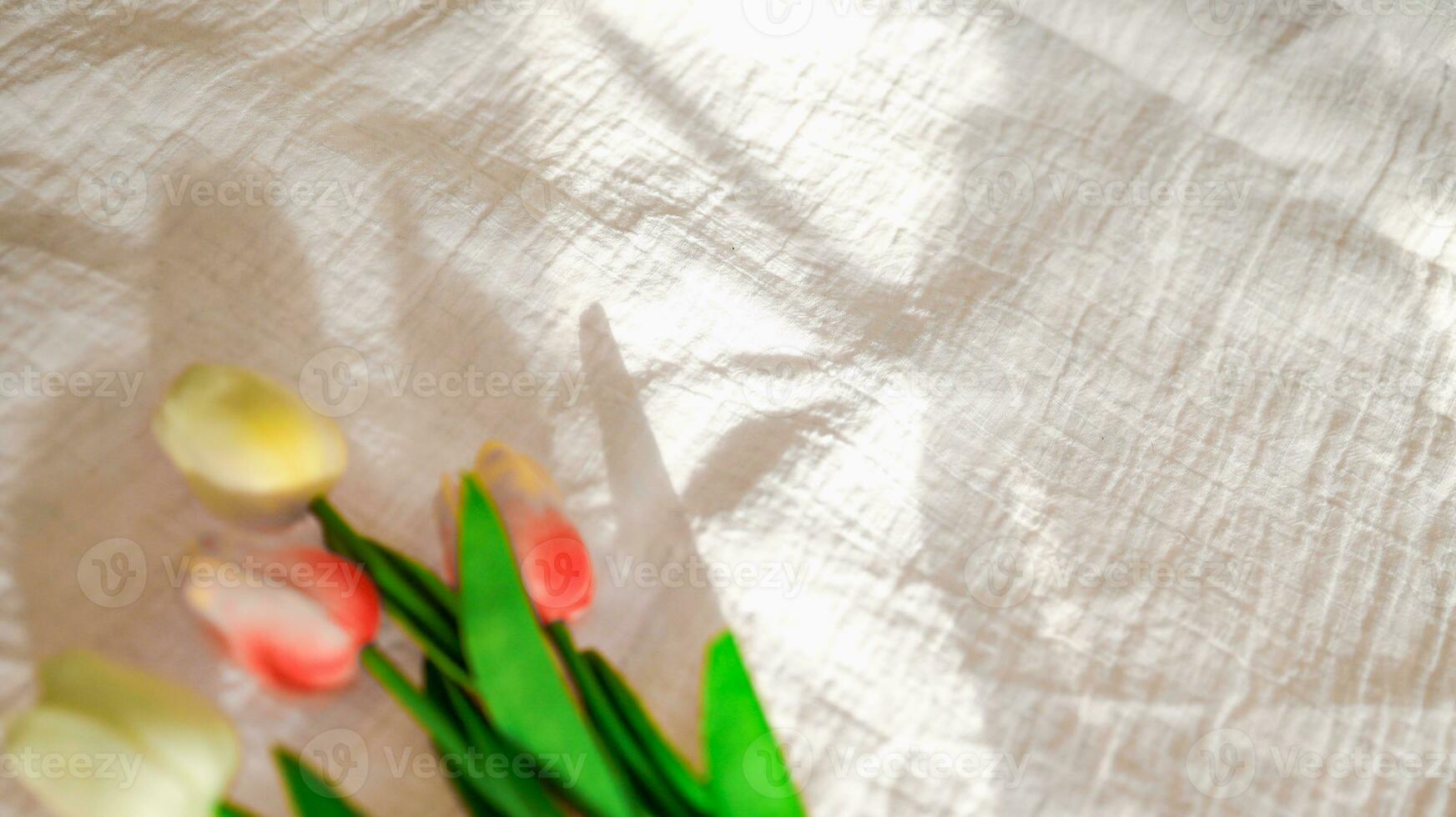 Tulip with Fabric backdrop White linen canvas crumpled natural cotton fabric Natural handmade linen top view background Organic Eco textiles White Fabric texture photo