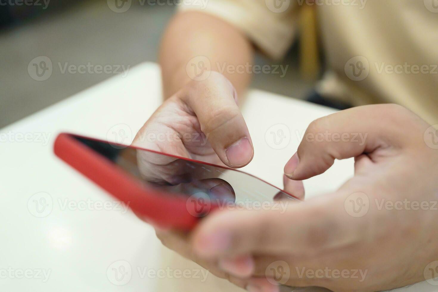 Relaxed young asian man using smart phone  spending time checking news social media. photo