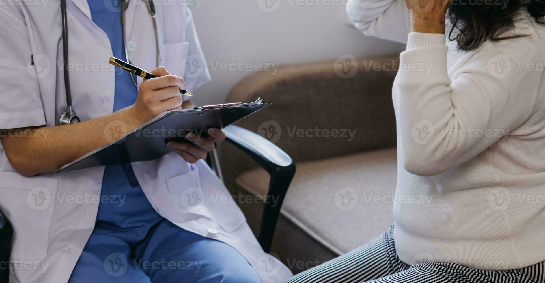 Homecare nursing service and elderly people cardiology healthcare. Close up of young hispanic female doctor nurse check mature caucasian man patient heartbeat using stethoscope during visit photo