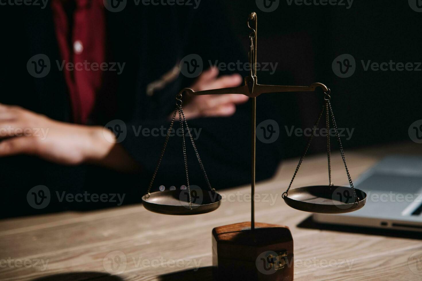 Justice and law concept.Male judge in a courtroom with the gavel, working with, computer and docking keyboard, eyeglasses, on table in morning light photo