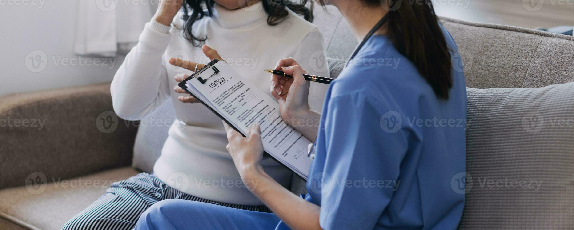 Homecare nursing service and elderly people cardiology healthcare. Close up of young hispanic female doctor nurse check mature caucasian man patient heartbeat using stethoscope during visit photo