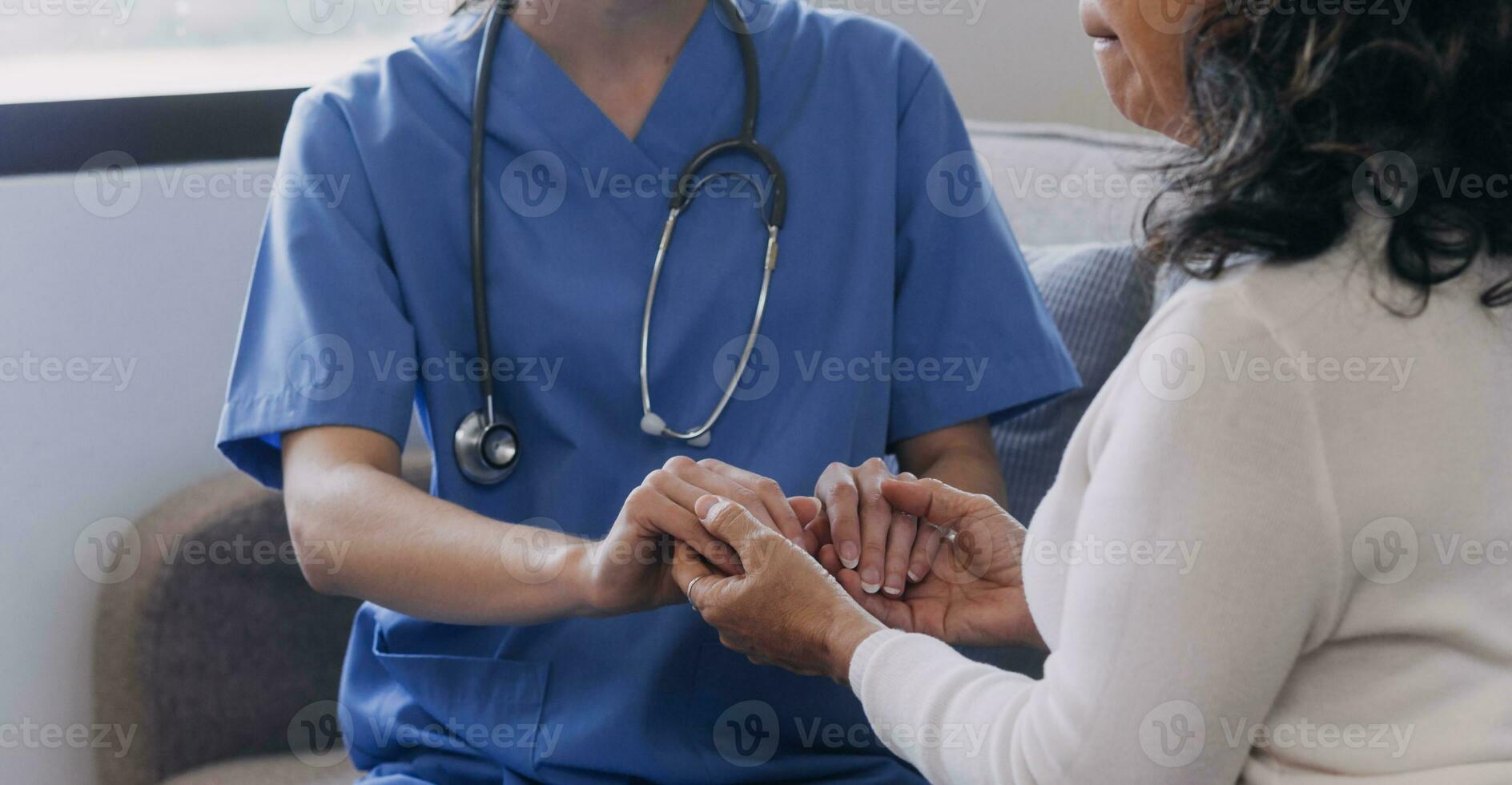 Homecare nursing service and elderly people cardiology healthcare. Close up of young hispanic female doctor nurse check mature caucasian man patient heartbeat using stethoscope during visit photo