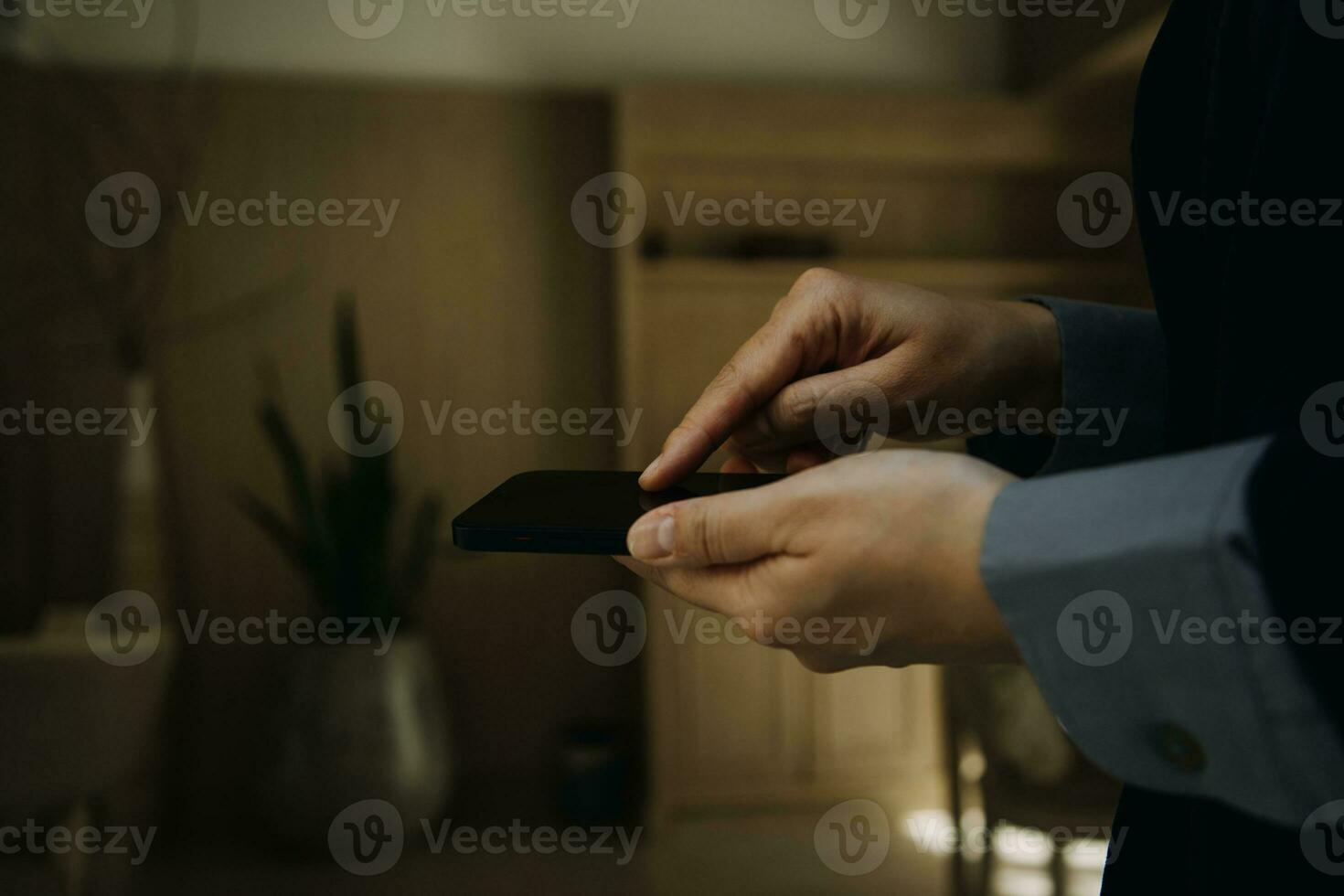 Mature businessman using a digital tablet to discuss information with a younger colleague in a modern business lounge photo