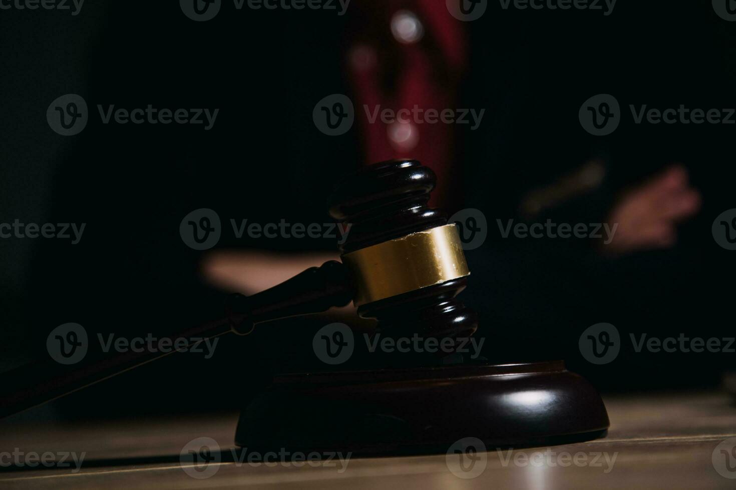 Justice and law concept.Male judge in a courtroom with the gavel, working with, computer and docking keyboard, eyeglasses, on table in morning light photo