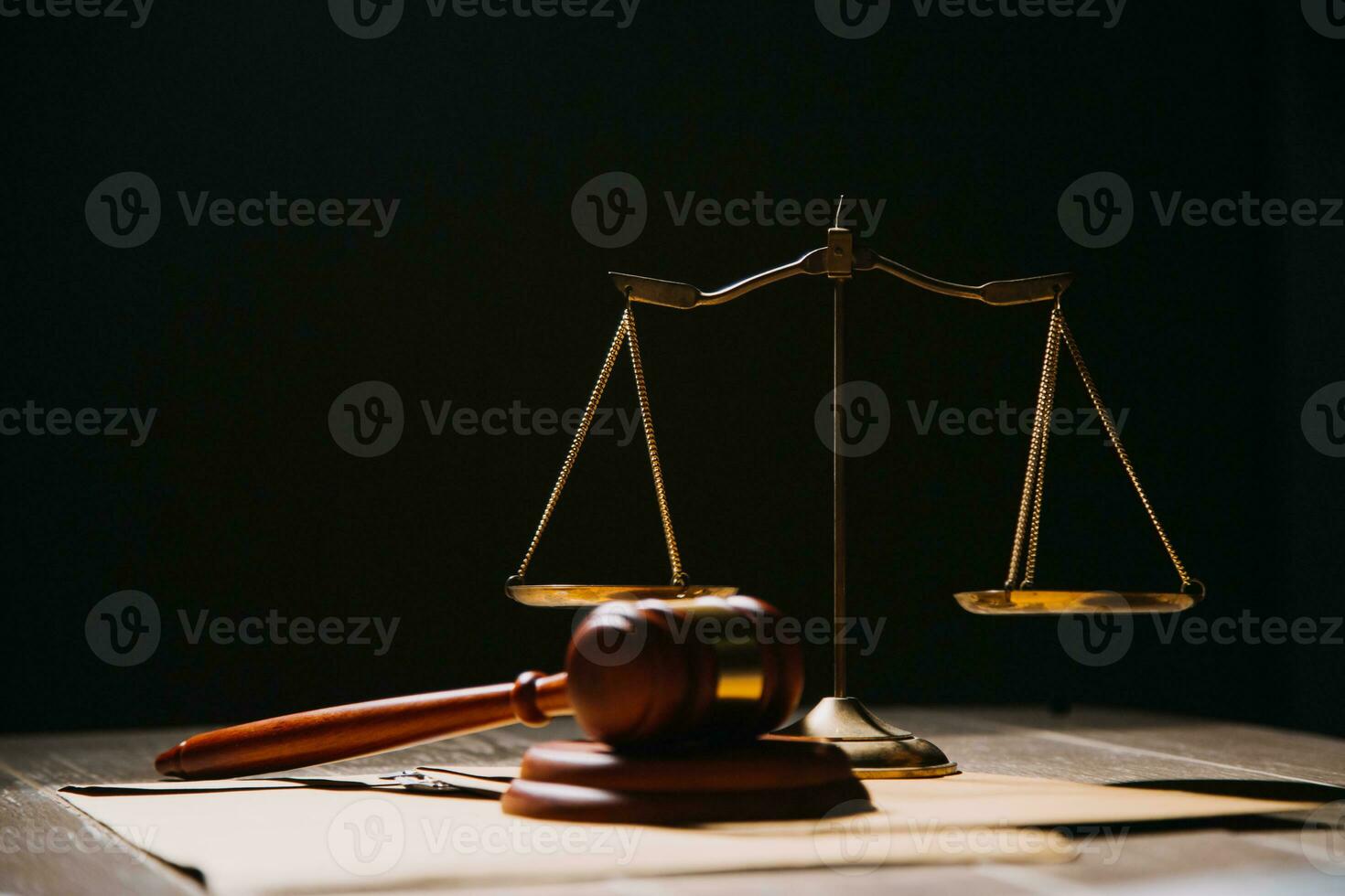 Justice and law concept.Male judge in a courtroom with the gavel, working with, computer and docking keyboard, eyeglasses, on table in morning light photo