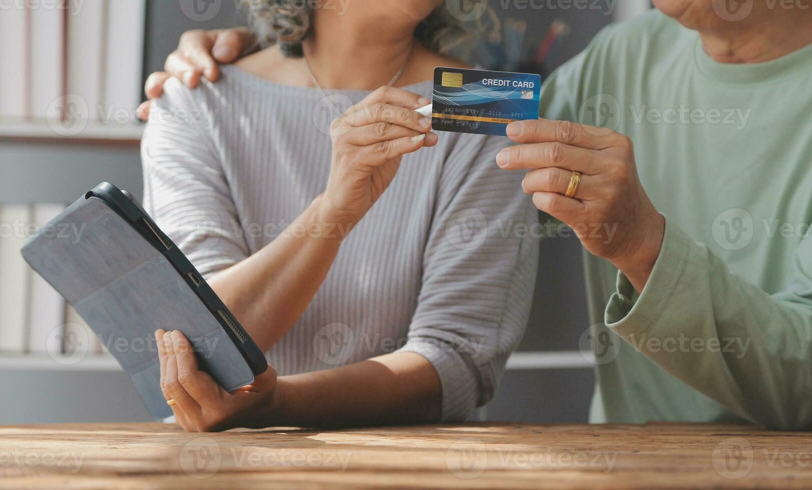 Close up mature man holding plastic credit card, senior couple family paying online, using laptop, satisfied older customers making secure internet payment, shopping, browsing banking service photo