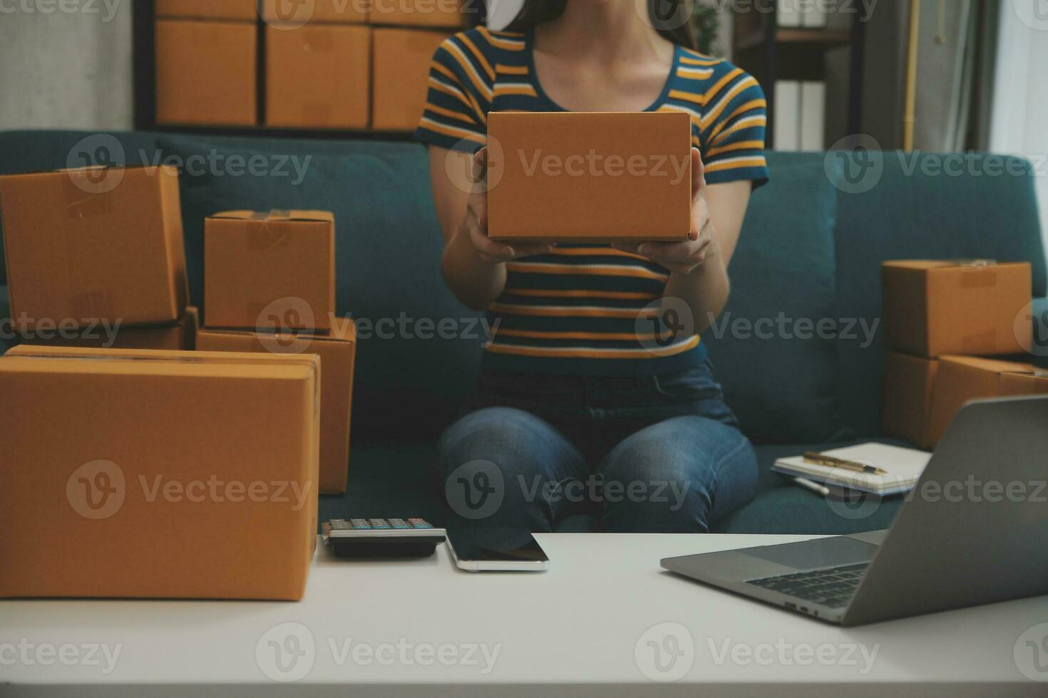 Business woman start up small business entrepreneur SME success .freelance woman working at home with Online Parcel delivery. SME and packaging deliveryconcept photo