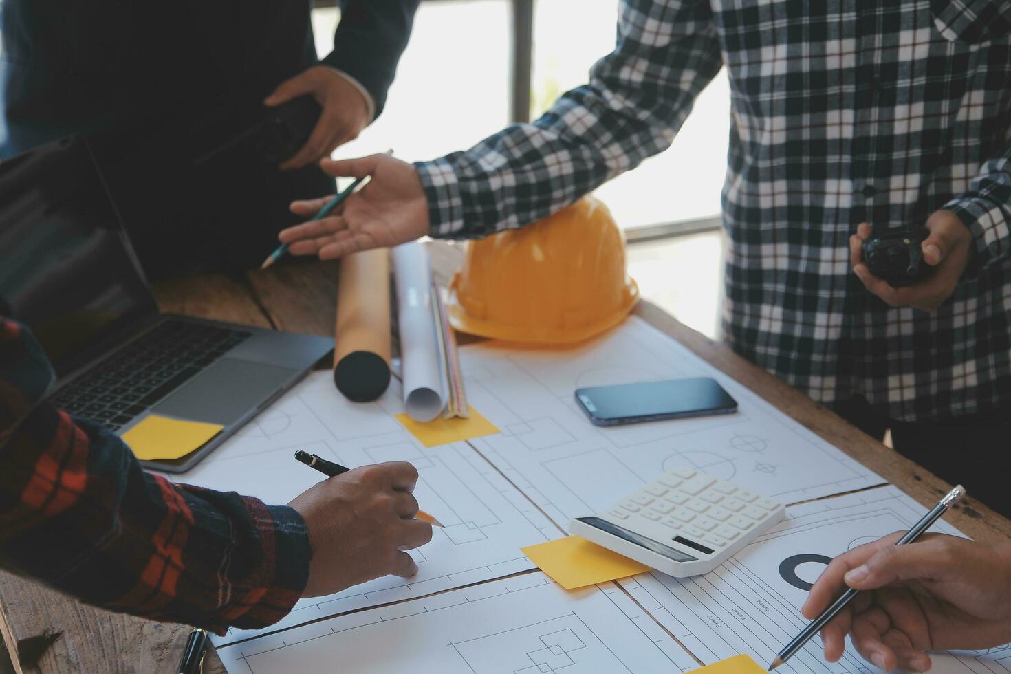 Engineer Teamwork Meeting, Drawing working on blueprint meeting for project working with partner on model building and engineering tools in working site, Construction and structure concept. photo