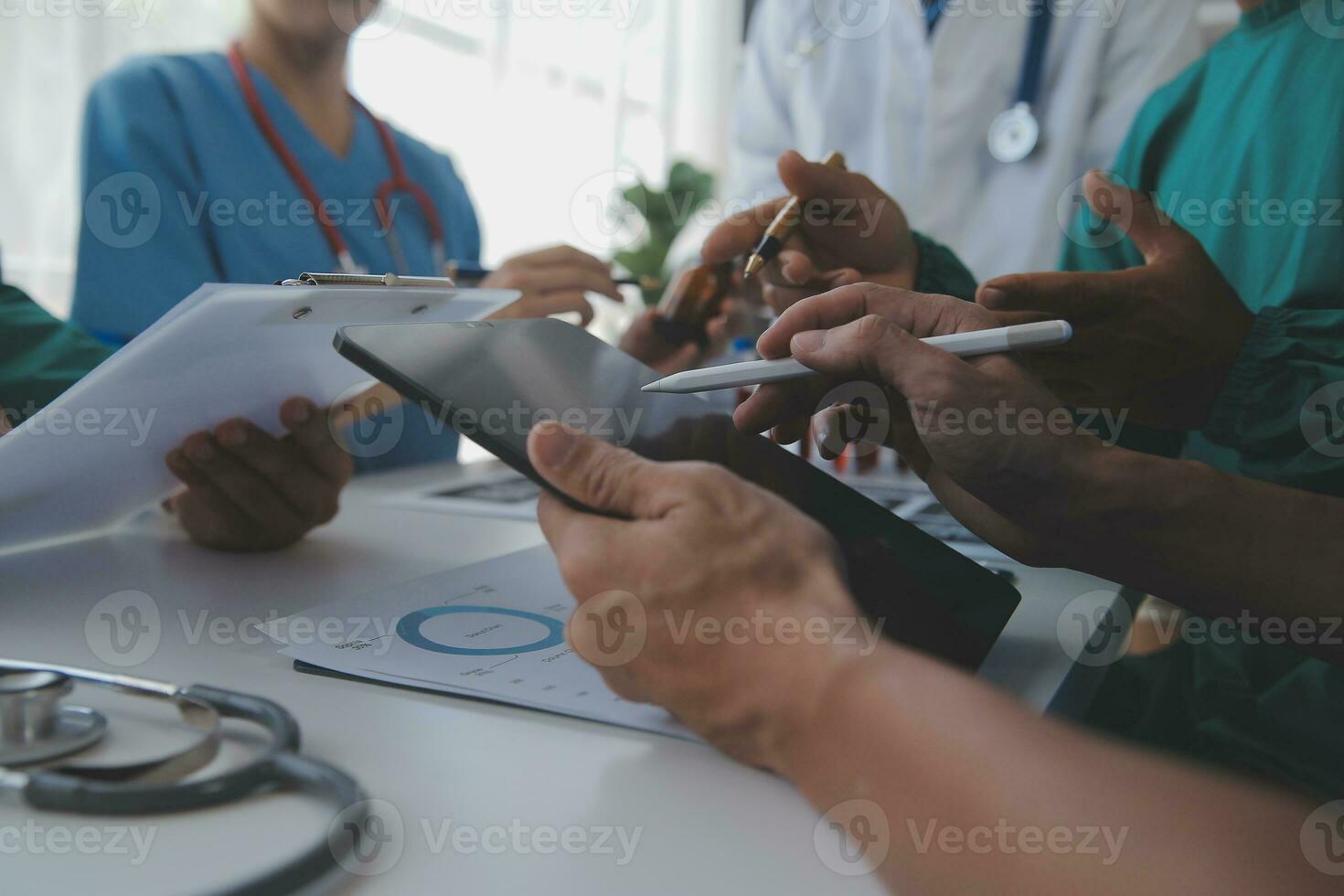 Medical technology network team meeting concept. Doctor hand working smart phone modern digital tablet laptop computer graphics chart interface, sun beams effect photo