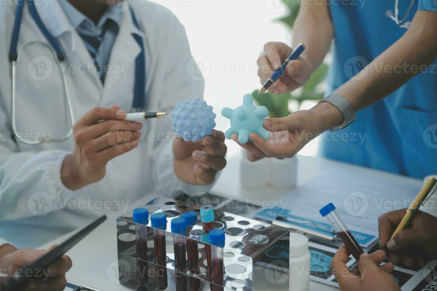 Medical technology network team meeting concept. Doctor hand working smart phone modern digital tablet laptop computer graphics chart interface, sun beams effect photo