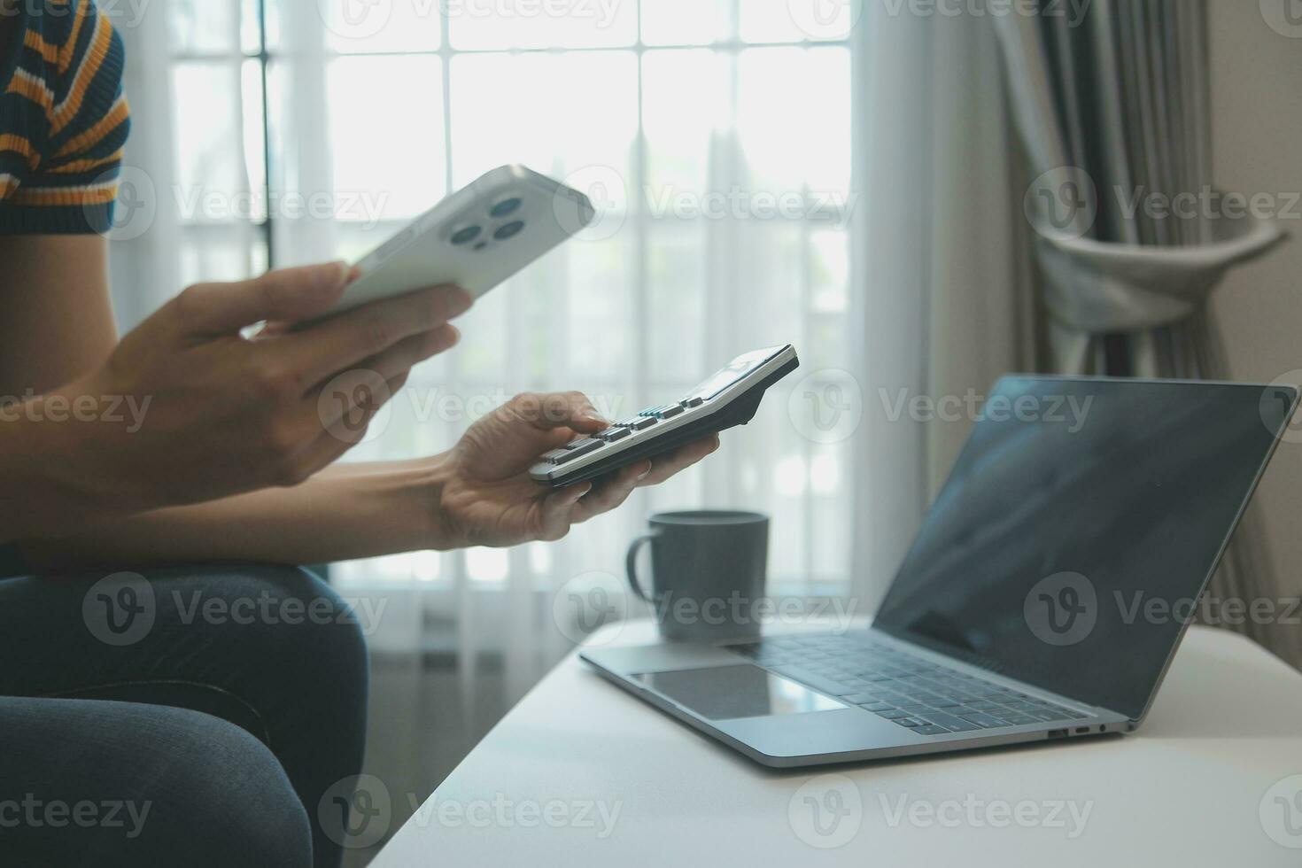 Young adult happy smiling Hispanic Asian student wearing headphones talking on online chat meeting using laptop in university campus or at virtual office. College female student learning remotely. photo