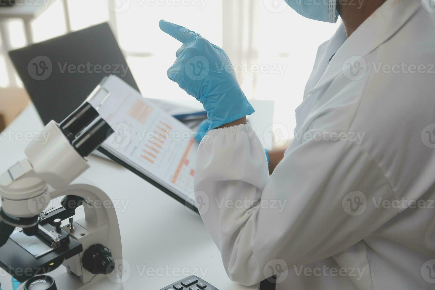 Professional lab. Amazing longhaired medical worker wearing uniform while using microscope during research photo