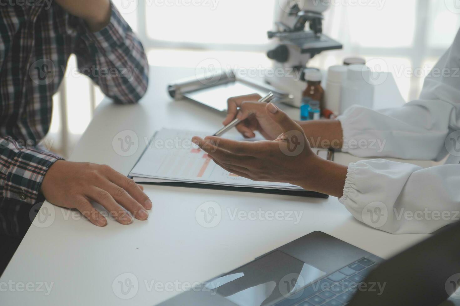 Professional lab. Amazing longhaired medical worker wearing uniform while using microscope during research photo