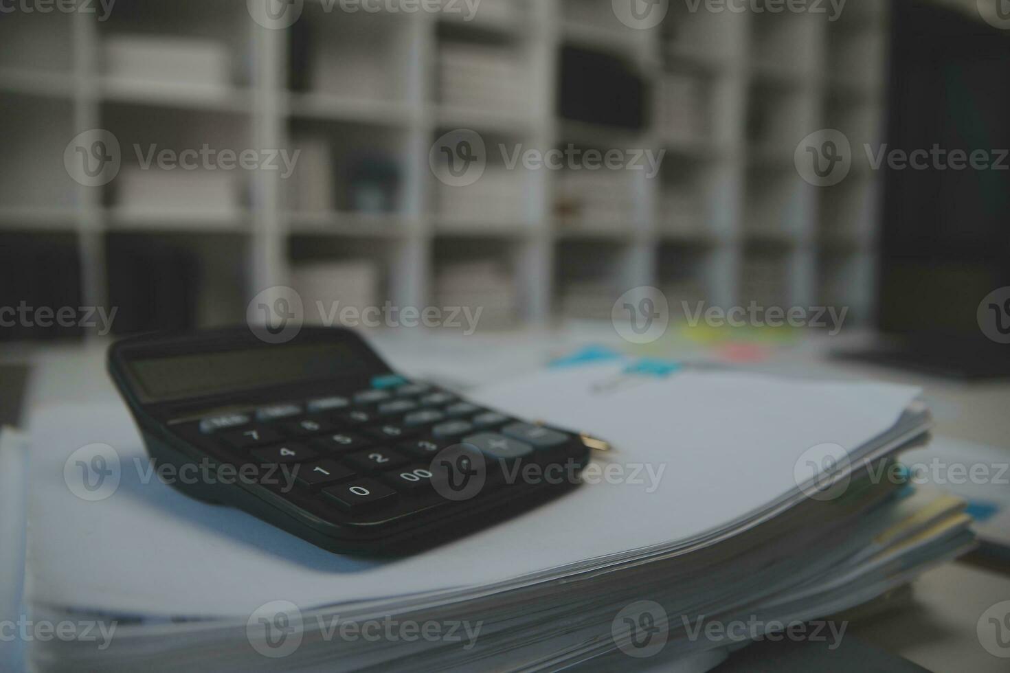 Business accounting concept, Business Man using calculator with computer laptop,pen, budget and loan paper in office. photo