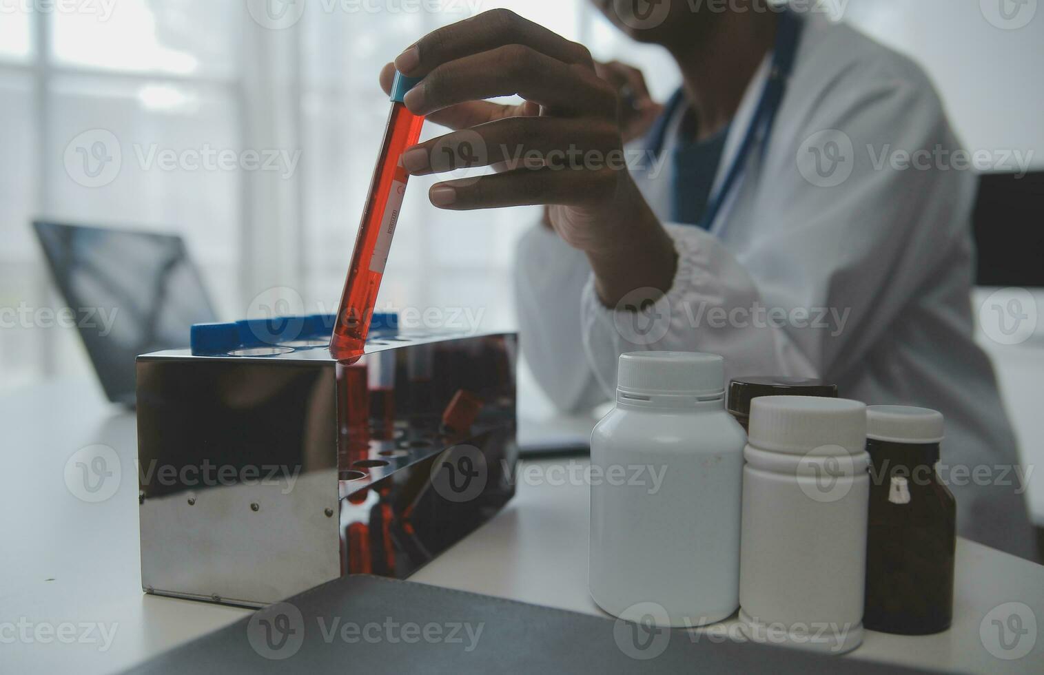 Professional lab. Amazing longhaired medical worker wearing uniform while using microscope during research photo