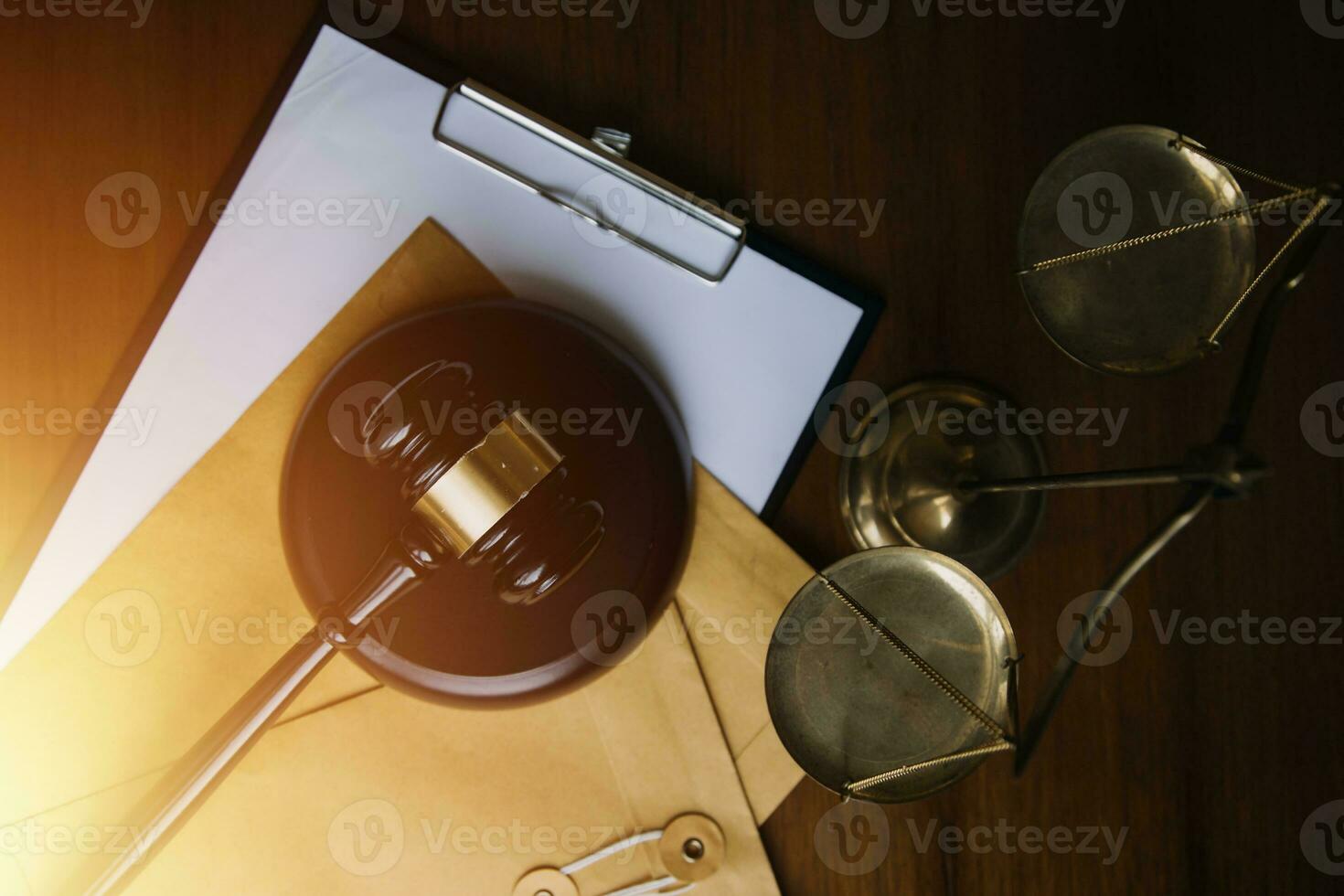 Justice and law concept.Male judge in a courtroom with the gavel, working with, computer and docking keyboard, eyeglasses, on table in morning light photo