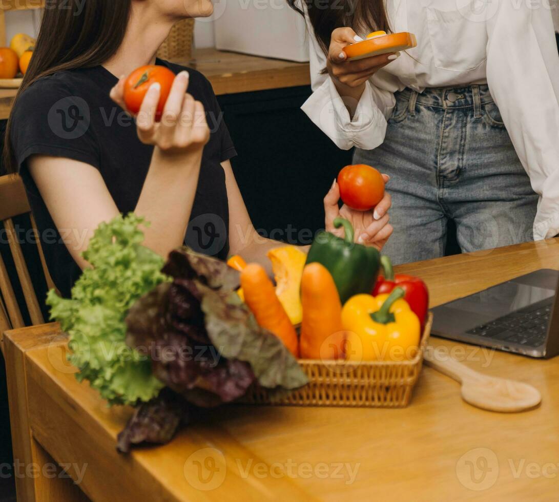 Laughing group of diverse young woman hanging out at home together and eating pizza photo