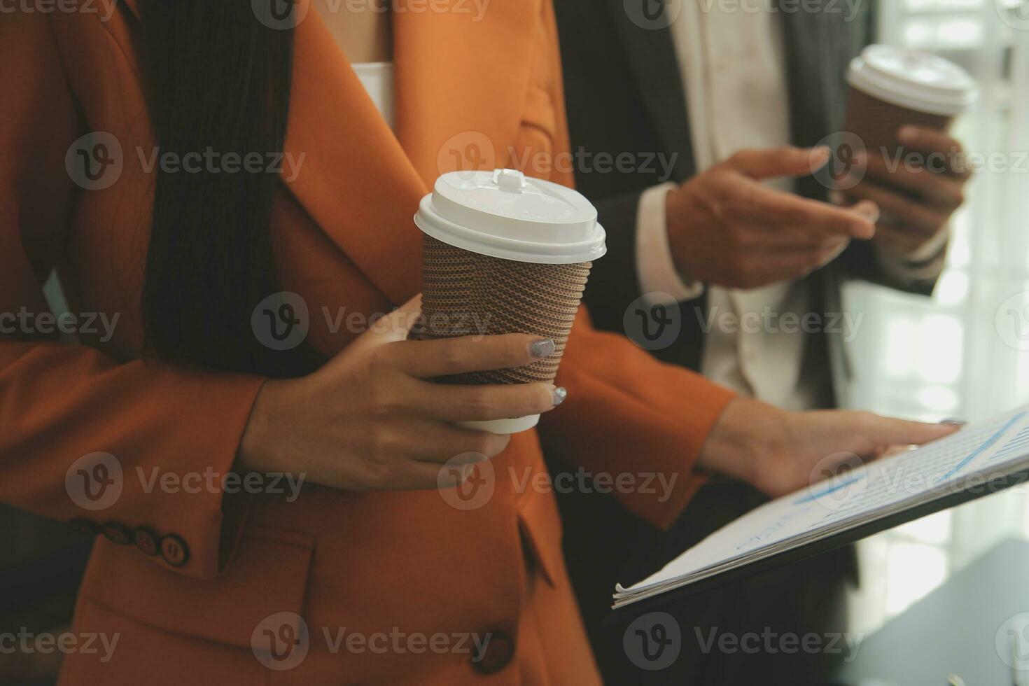 Entrepreneur Asian businessman and businesswoman discussing new business project in tablet in modern Meeting In Modern Office, Asian business casual concept. photo