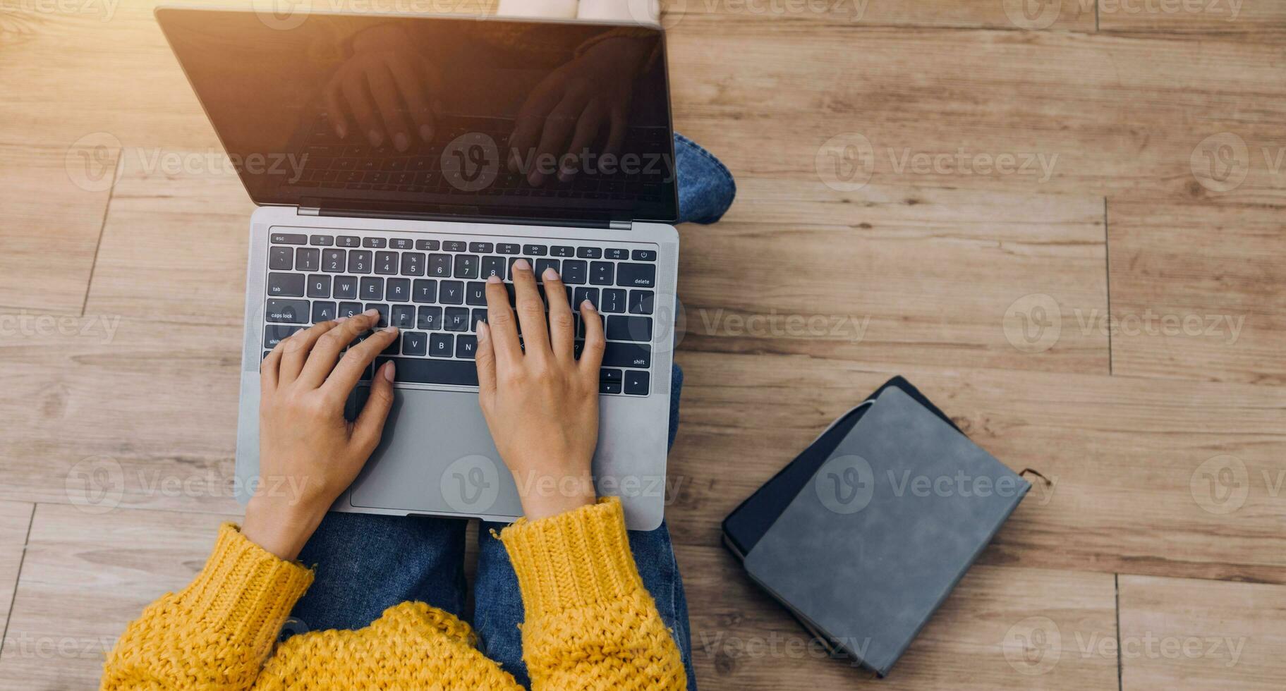 Young adult happy smiling Hispanic Asian student wearing headphones talking on online chat meeting using laptop in university campus or at virtual office. College female student learning remotely. photo