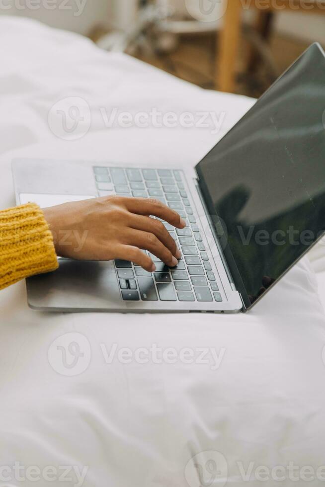 Young adult happy smiling Hispanic Asian student wearing headphones talking on online chat meeting using laptop in university campus or at virtual office. College female student learning remotely. photo