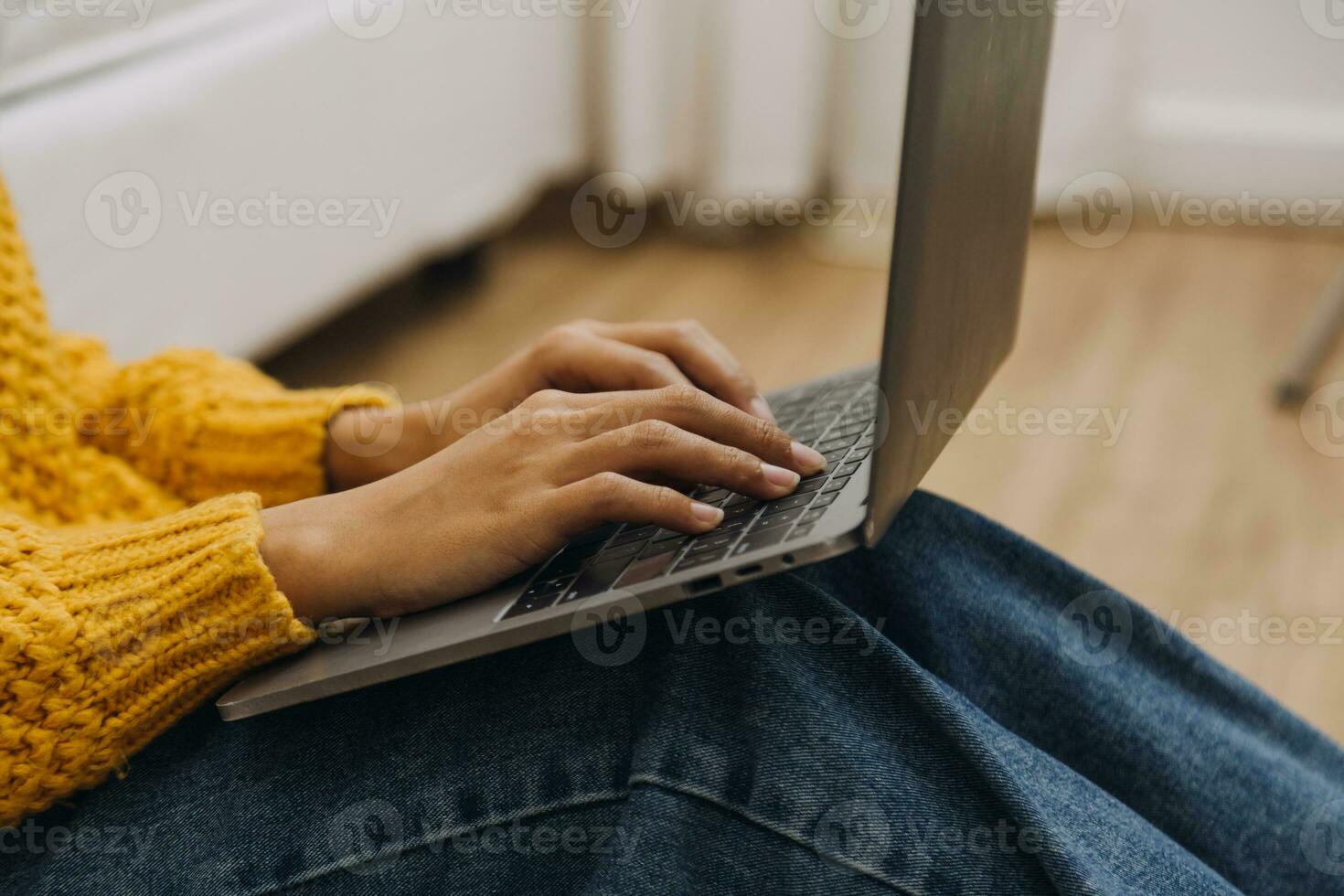 Young adult happy smiling Hispanic Asian student wearing headphones talking on online chat meeting using laptop in university campus or at virtual office. College female student learning remotely. photo