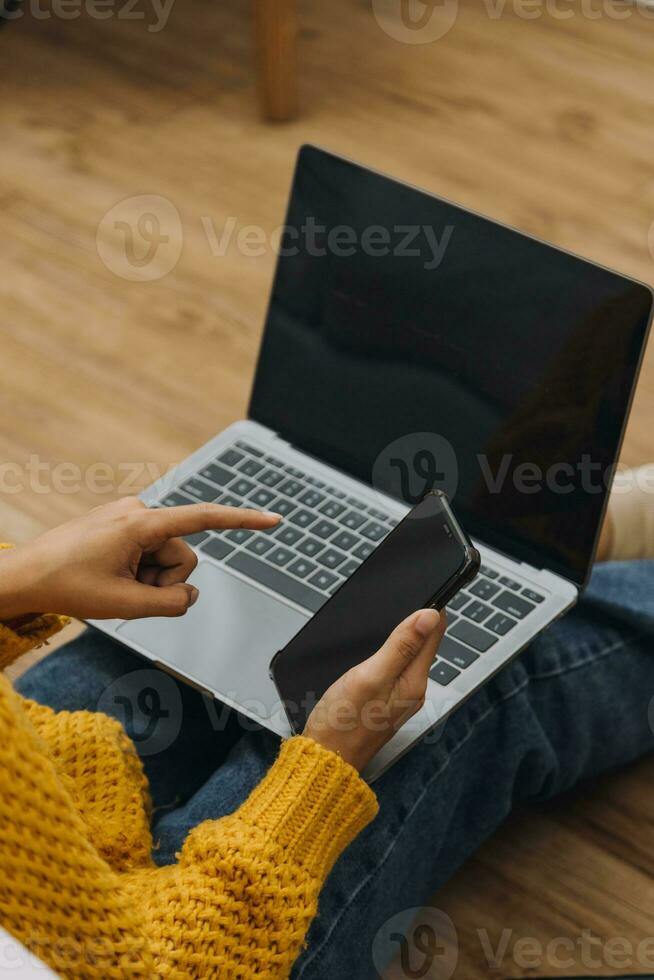 Young adult happy smiling Hispanic Asian student wearing headphones talking on online chat meeting using laptop in university campus or at virtual office. College female student learning remotely. photo