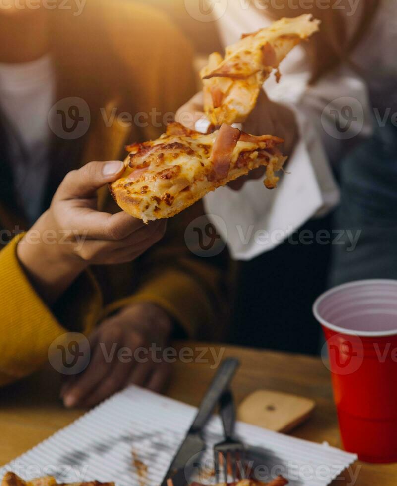 Friends hangout. Young female celebrating birthday party at weekend at home, eating pizza, drinking champagne, party, lifestyle, friendship photo