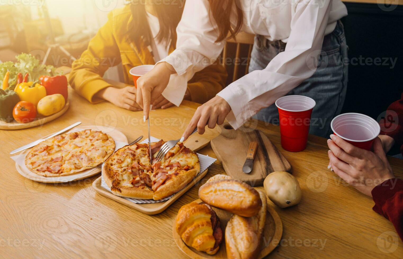 Friends hangout. Young female celebrating birthday party at weekend at home, eating pizza, drinking champagne, party, lifestyle, friendship photo