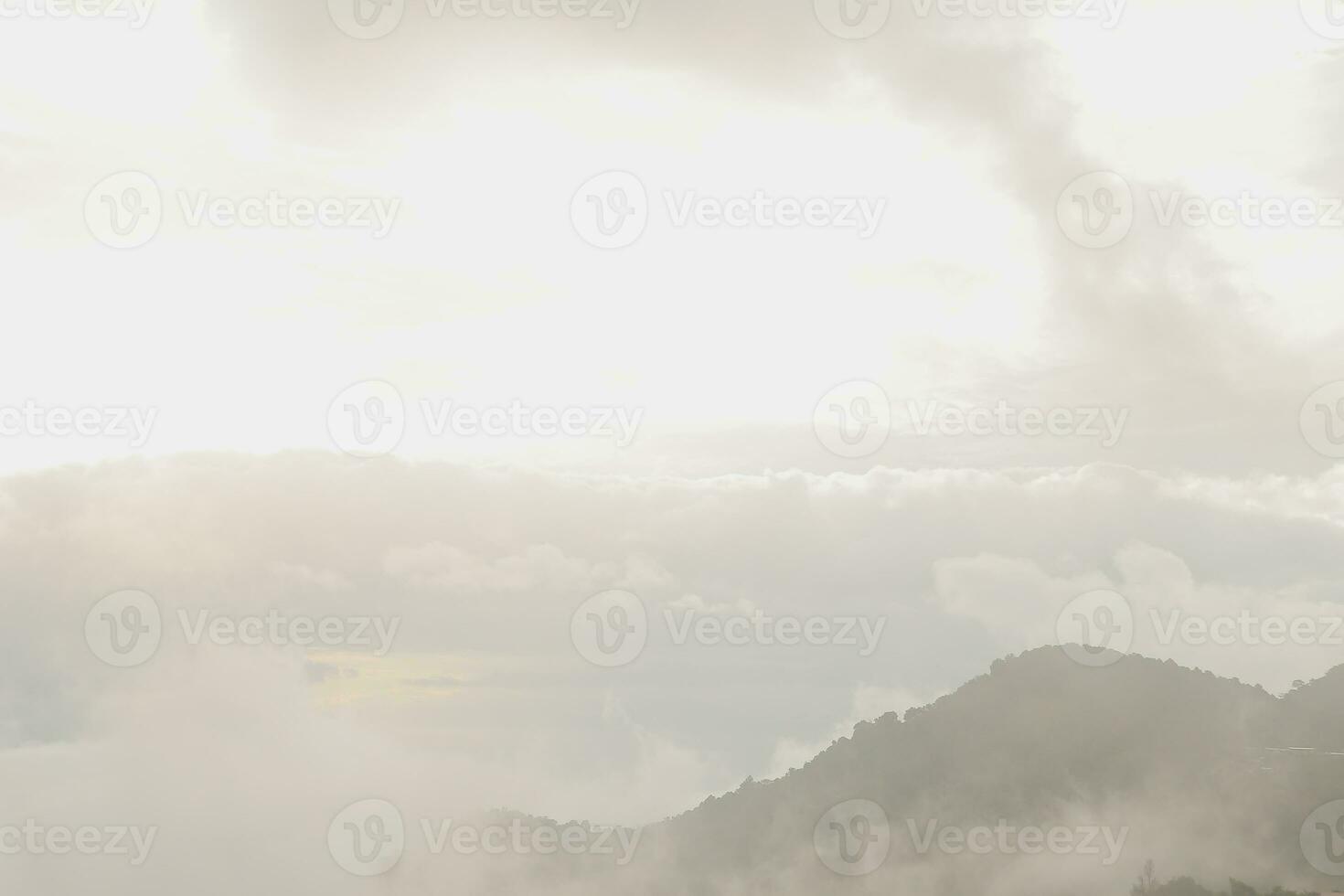 Mountain range with visible silhouettes through the morning blue fog. photo