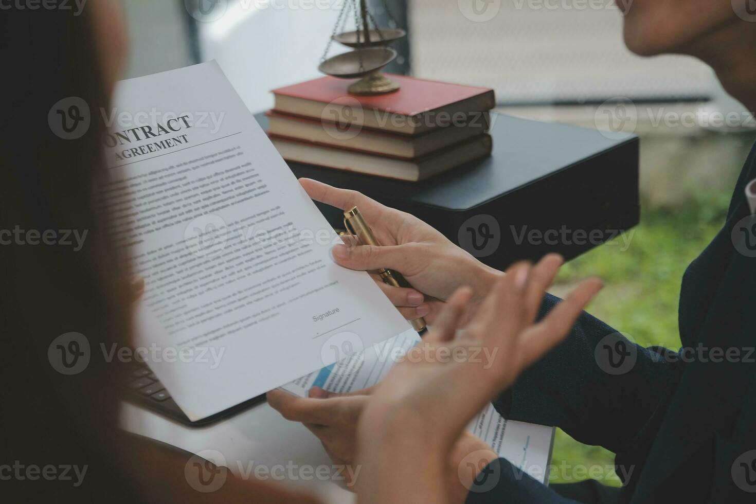 Business and lawyers discussing contract papers with brass scale on desk in office. Law, legal services, advice, justice and law concept picture with film grain effect photo